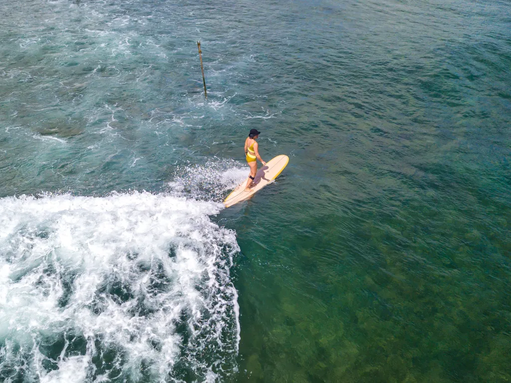 longboarder in the ocean in Sri Lanka