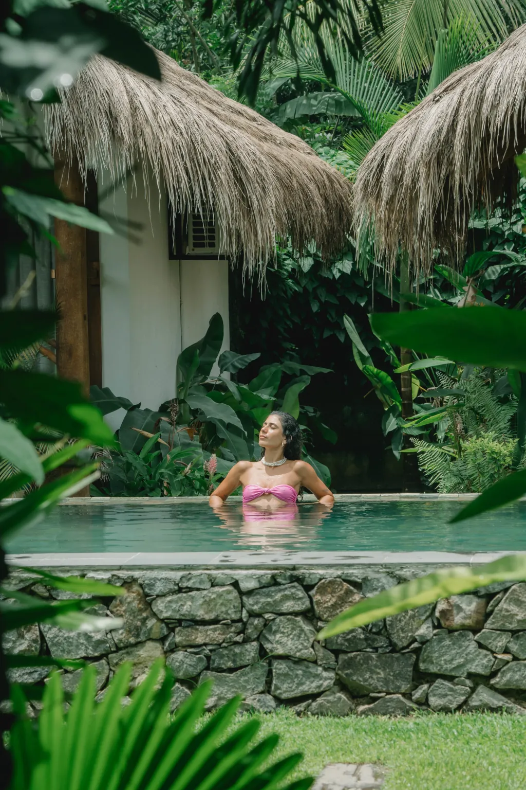 A guest relaxing a our pool in Hiriketiya