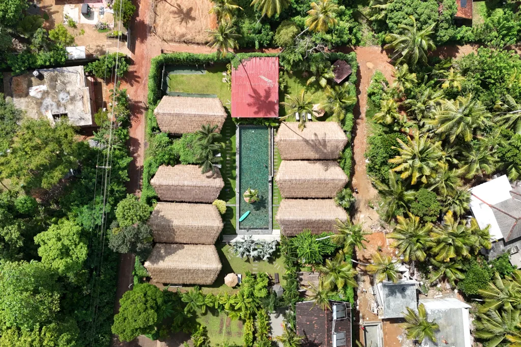 drone shot of Hiriketiya camp with private bungalows surrounding a pool