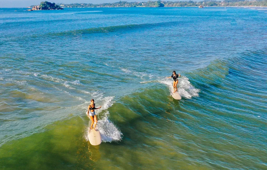 Two longboarders in the Indian ocean, working on their cross-stepping