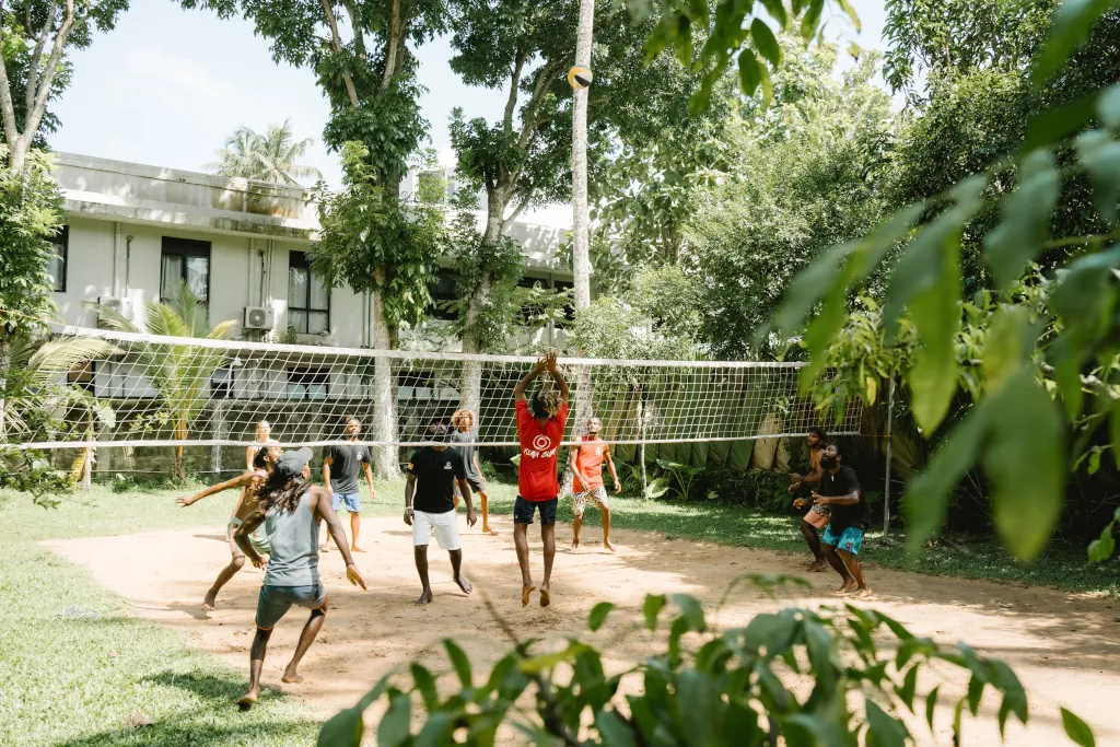 group of kima guests playing beach volleyball