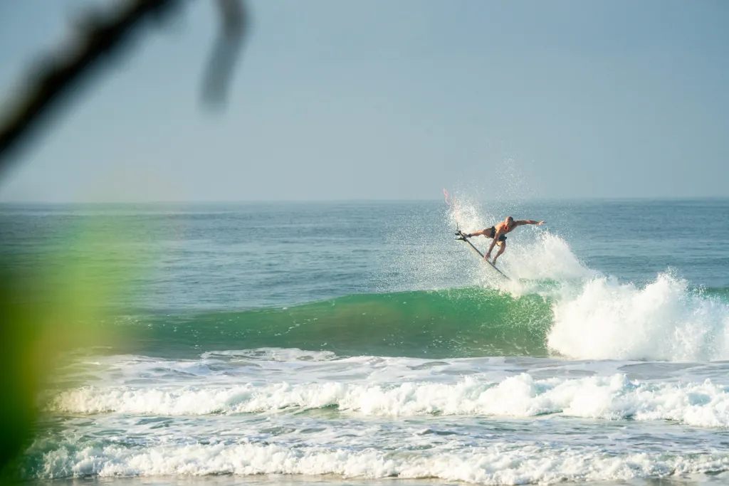 A surfer surfing in Weligama