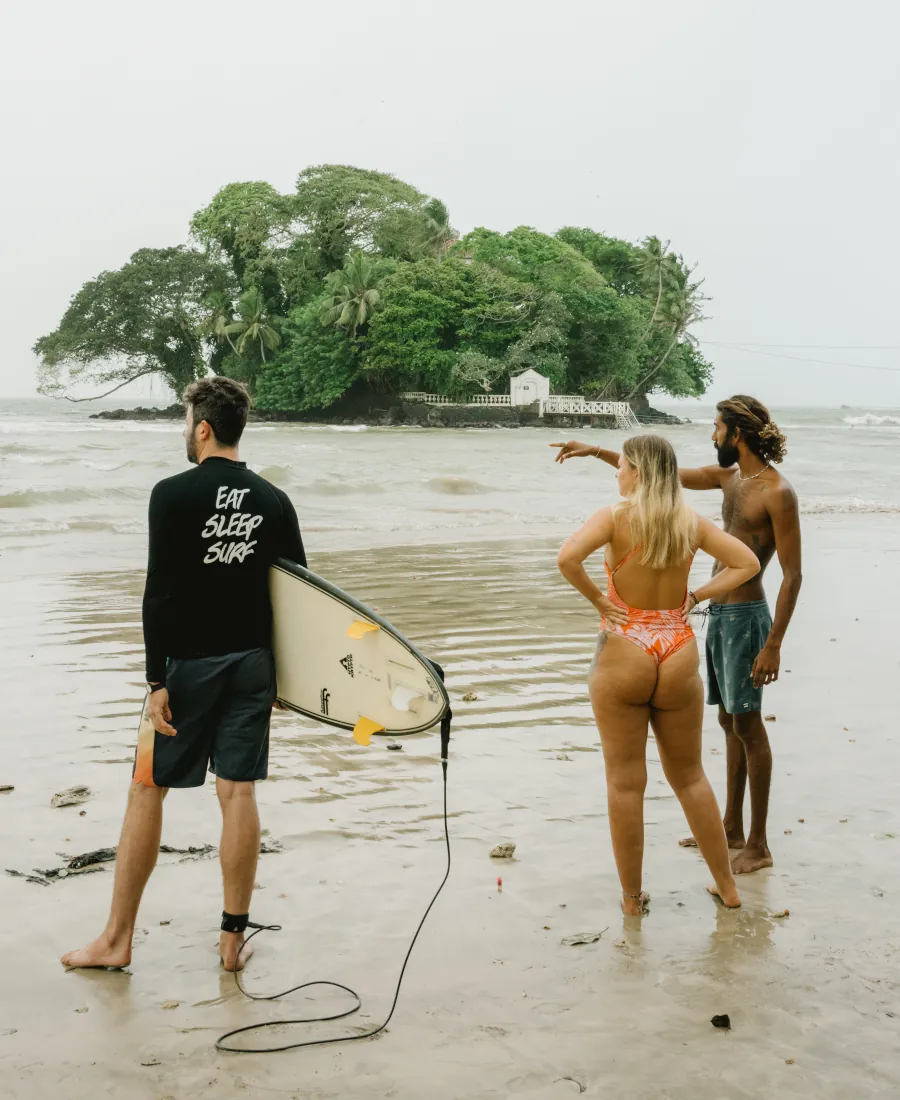 Kima Surf coach giving a surf lesson on the beach at Weligama Bay Sri Lanka