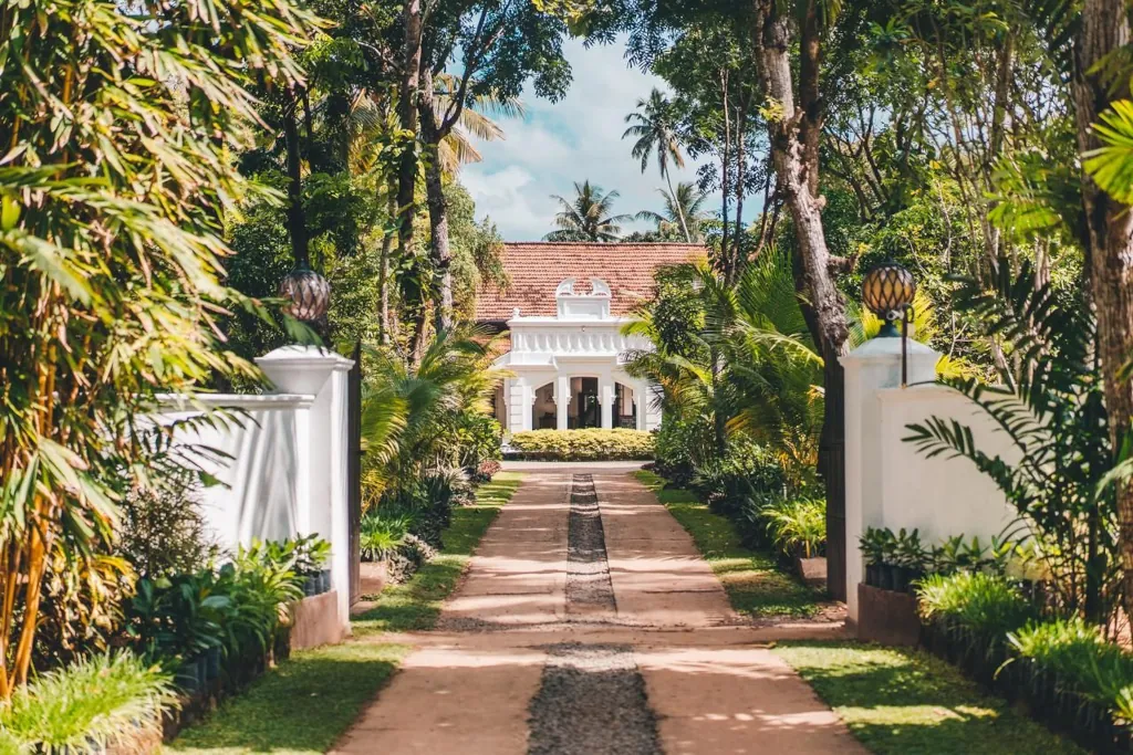 outside image of Kima weligama, with a gate leading to the surf camp