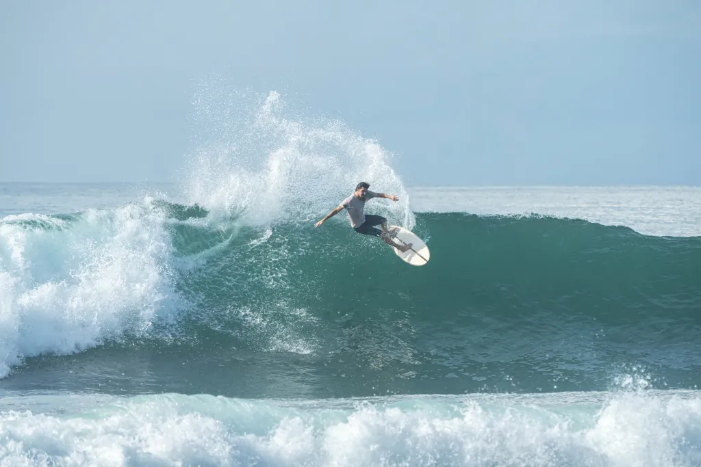 Surfer surfing lazy left in Sri Lanka